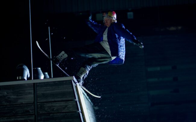 Snowboarder Clemens Millauer doing a trick in the Red Bull Arena Salzburg