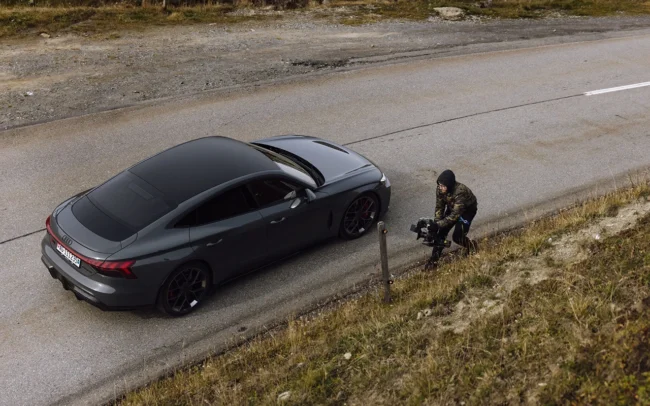 Director of Photography Imanuel Thallinger filming a close up shot of the new AUDI RS e-tron GT passing him by. Photo by Patrick Güller.