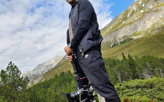 Camera operator getting ready for the next shot, filming with a gimbal.