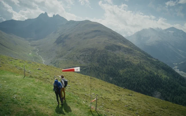 Magdalena and Elisa standing next to a vane deciding where to paraglide from.