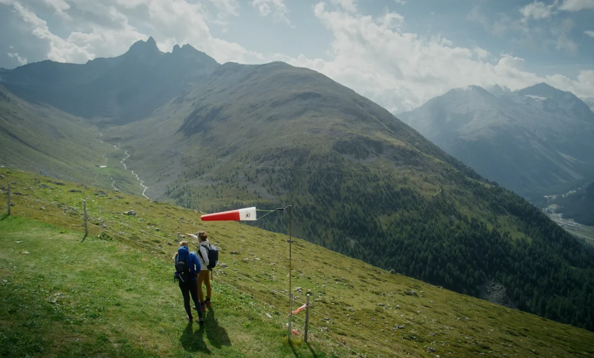 Elisa Deutschmann and Magdalena Mittersteiner looking for a paragliding start point on a mountain in France.