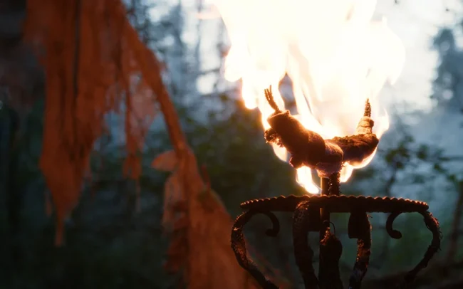 A totem burning in the camp of the witch of HECATE.