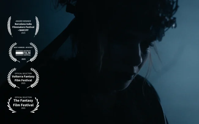 A silhouetted witch stands in the dark. Thumbail for our film HECATE: