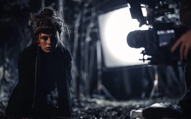 Selina Pöstinger who plays the witch in Hecate is filmed with a camera in a dark forest.
